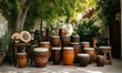 © jambulart - Many drums displayed outdoors, leafy background.