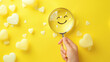 © Mutshino_Artwork - Hand holding magnifying glass with smiley face surrounded by hearts on a bright yellow background
