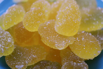 Poster - A bright blue bowl filled with colorful yellow gummy bears.