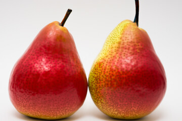 A close up of three pears on a white surface. A white background with pears and white fruit. Pear fruit white background red. A white and red fruit with a pear on lifestyle a white background.