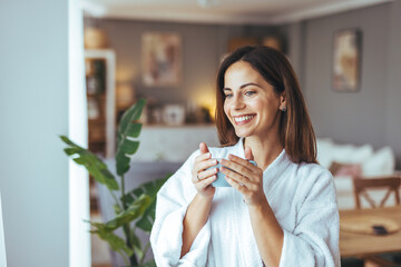 Wall Mural - Woman Enjoying a Relaxing Morning Coffee in a Cozy Home