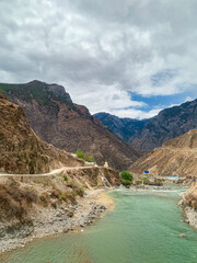 Wall Mural - Views of Tibetan houses, green field and mountains along the road from Shangri La to Yading, Sichuan 