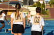 © Austockphoto - children at netball training on blue playing surface and