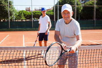 Wall Mural - Senior man posing on tennis court