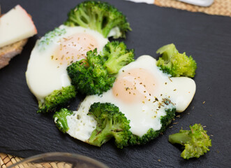 Wall Mural - Breakfast of crumpled eggs with broccoli