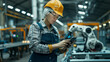 © Delphotostock - Middle aged worker woman wearing a security hemet working in a modern factory with a robotic arm and phone,controlling  automation in industry, human working with automated machines