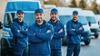 © Lion - team of three delivery personnel in blue uniforms standing together in front of a row of delivery vans urban outdoor location clear lighting