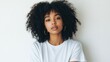 © Viacheslav - Portrait of young curly pretty cool generation z African woman wearing t-shirt standing isolated on white background. Confident ethnic Afro American female model looking at camera.