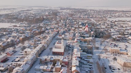 Wall Mural - Aerial view of city center and residential neighborhood with houses and road streets covered in snow. Winter season in small European town