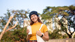 © ChayTee - Go green Gen Z woman asia young people smile looking at camera protect save the earth planet world care in city tree public park. Asian hope net zero waste reduce social issues by reuse eco tote bag.