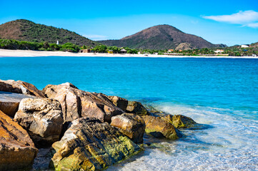 Wall Mural - rocky shoreline with a body of water in the background