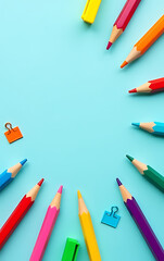 Aufkleber - Colorful stationery items like pencils, markers, and paper clips are displayed on a soft pastel blue background in this back to school theme._00001_