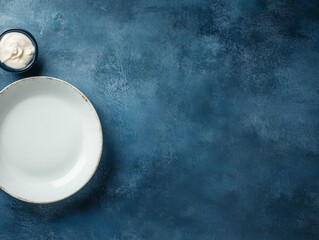 Poster - Ceramic plate rests on a gray stone table, inviting creativity with space for text or food preparation, enhancing any culinary display or presentation