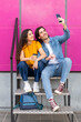 © VISTA by Westend61 - Smiling man taking selfie with woman on mobile phone