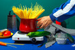 © VISTA by Westend61 - Hand of man holding pot full of spaghetti in studio