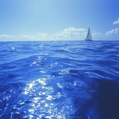 Wall Mural - Sailboat on calm blue ocean under a sunny sky.