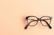 © Boris - Black eyeglasses on pale background, simplicity and clarity concept.