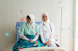 © Art_Photo - Muslim doctor celebrating new year with patient in hospital joyful healthcare, medical staff and patient bonding, festive mood, confetti party, hospital celebration inclusive healthcare moments