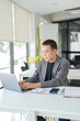 © Charlie's - Asian Business man working with laptop. Young business man thinking Concentrated at work.