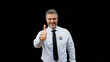 © Synthex🇺🇦 - Successful election candidate gives a thumbs-up, isolated on a black background