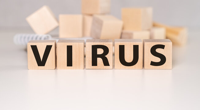 VIRUS text and symbols is written on wooden cubes as pandemic concept