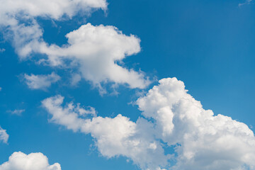 Wall Mural - blue sky with a clouds. Clear blue sky panoramic background with small white clouds. Partly cloudy. White fluffy clouds in the blue sky.