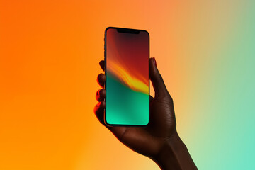 A hand holding an smartPhone with the screen facing forward, against a gradient background of orange and teal hues