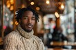 © Markus Schröder - Portrait of a satisfied afro-american man in his 30s dressed in a warm wool sweater over bustling city cafe