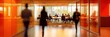 © David Giraud - Des femmes d'affaires et des hommes d'affaires marchant dans les bureaux d'une entreprise avec des silhouettes floues au premier plan.