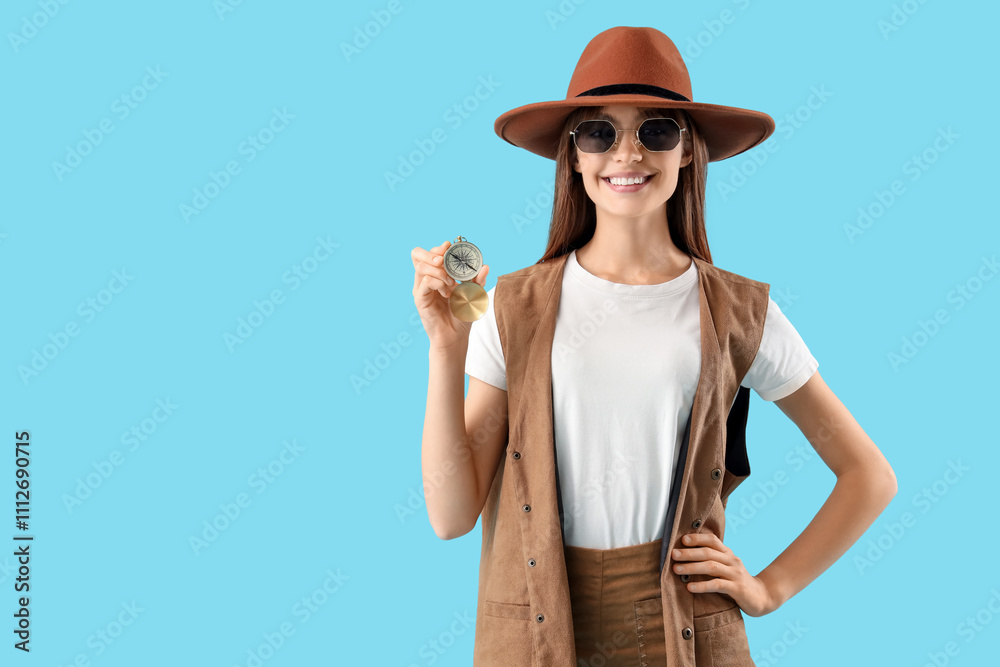 Female tourist with compass on blue background