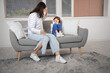 © Pixel-Shot - Angry mother threatening her little daughter on sofa at home. Domestic violence concept
