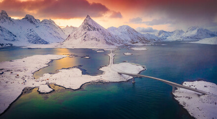 Canvas Print - Fantastic winter sunrise in Norway, Europe. Unbelievable morning scene of Lofoten Islands  with Fredvang bridge and Volandstind peak on background. Beautiful winter scenery..