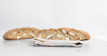 Wall Mural - almond biscotti on white marble countertop, almond cantucci cookies on a white board, slices of biscotti cookies or twice baked cookies