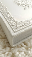 Embossed white photo album on fluffy rug.