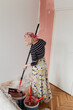 © Melika Tursic/Stocksy - Woman painting wall at home, first move