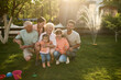 © Iuliia Versta/Stocksy - Portrait of large family playing on a backyard