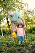 © Iuliia Versta/Stocksy - grandpa with his little granddaughter watered a plants