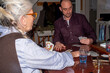 © tessy morelli/Stocksy - Senior mother and son winter evening playing cards
