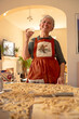© tessy morelli/Stocksy - Home Portrait senior woman cooking