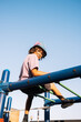 © Natalia Mishina/Stocksy - Child playing on playground.