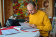 © tessy morelli/Stocksy - Man studying at home candid portrait