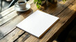 © Lizbond - A blank notebook and coffee on a rustic wooden table in a cozy café during the afternoon