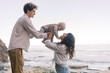 © Irina Efremova/Stocksy - Parents playing with baby on the beach