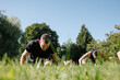 © Rob and Julia Campbell/Stocksy - Group Exercise in a Lush Park on a Sunny Day