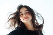 © Ева Поликарпова - A woman with long brown hair smiles, offering a warm and inviting expression