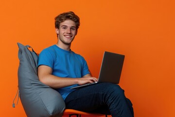 Leinwandbilder - A person sitting on a chair with a laptop, focused on work or study