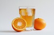 © Alla - A glass of fresh orange juice sits next to a juicy orange, perfect for a refreshing beverage or a healthy snack