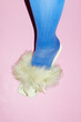 © Colour Laboratory/Stocksy - Person wearing blue tights and fashion  feather heels with flashlight