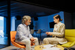 © BONNINSTUDIO/Stocksy - Financial advisors discussing strategy in office at late evening