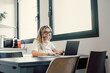 © Daniel - Happy millennial female in headphones watch webinar on laptop in modern office, smiling young businesswoman have fun laugh talk on video call with client or colleague use wireless Internet connection.